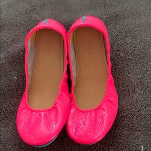 Tieks neon pink flats.